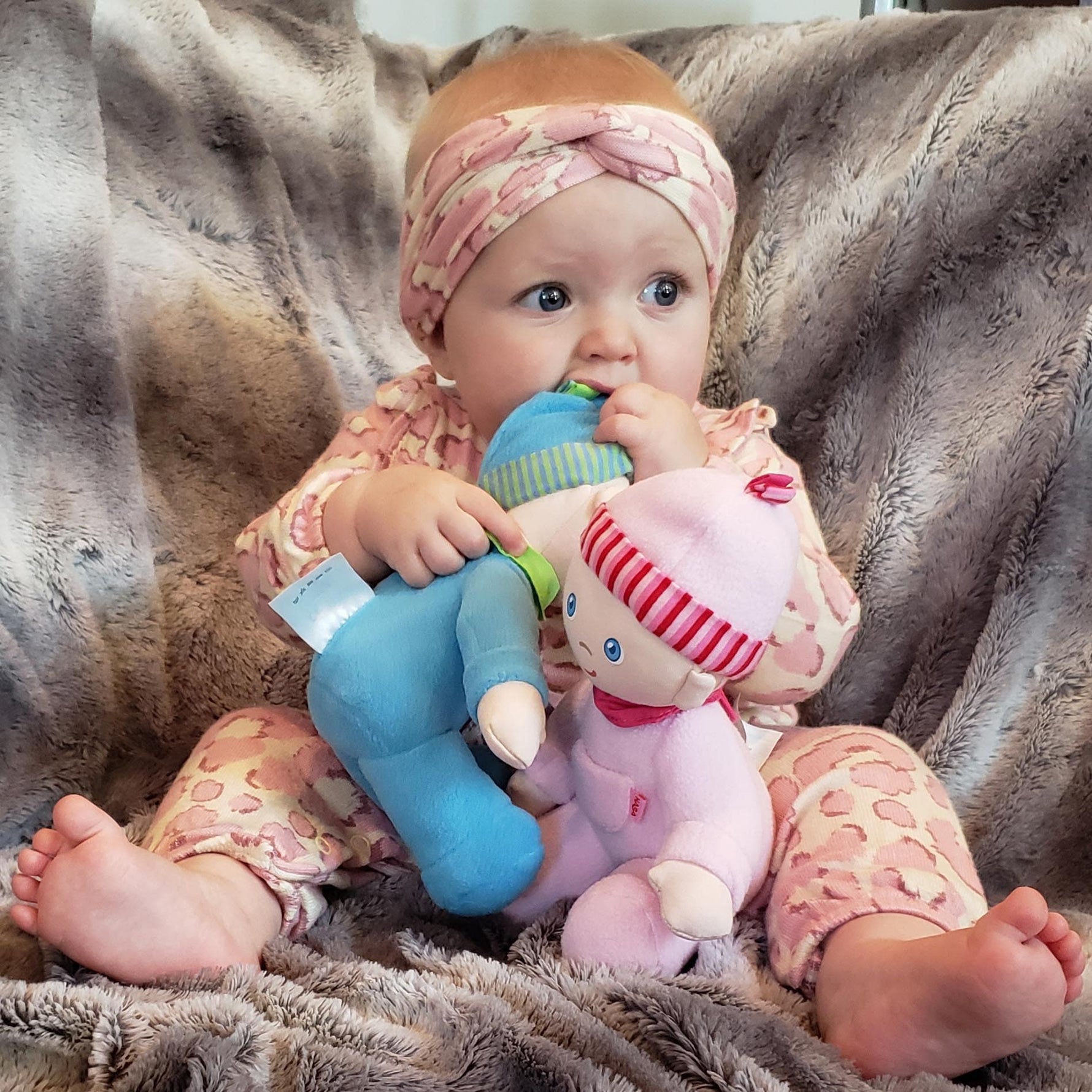 My First Snug Up Luis baby doll sitting by HABA USA