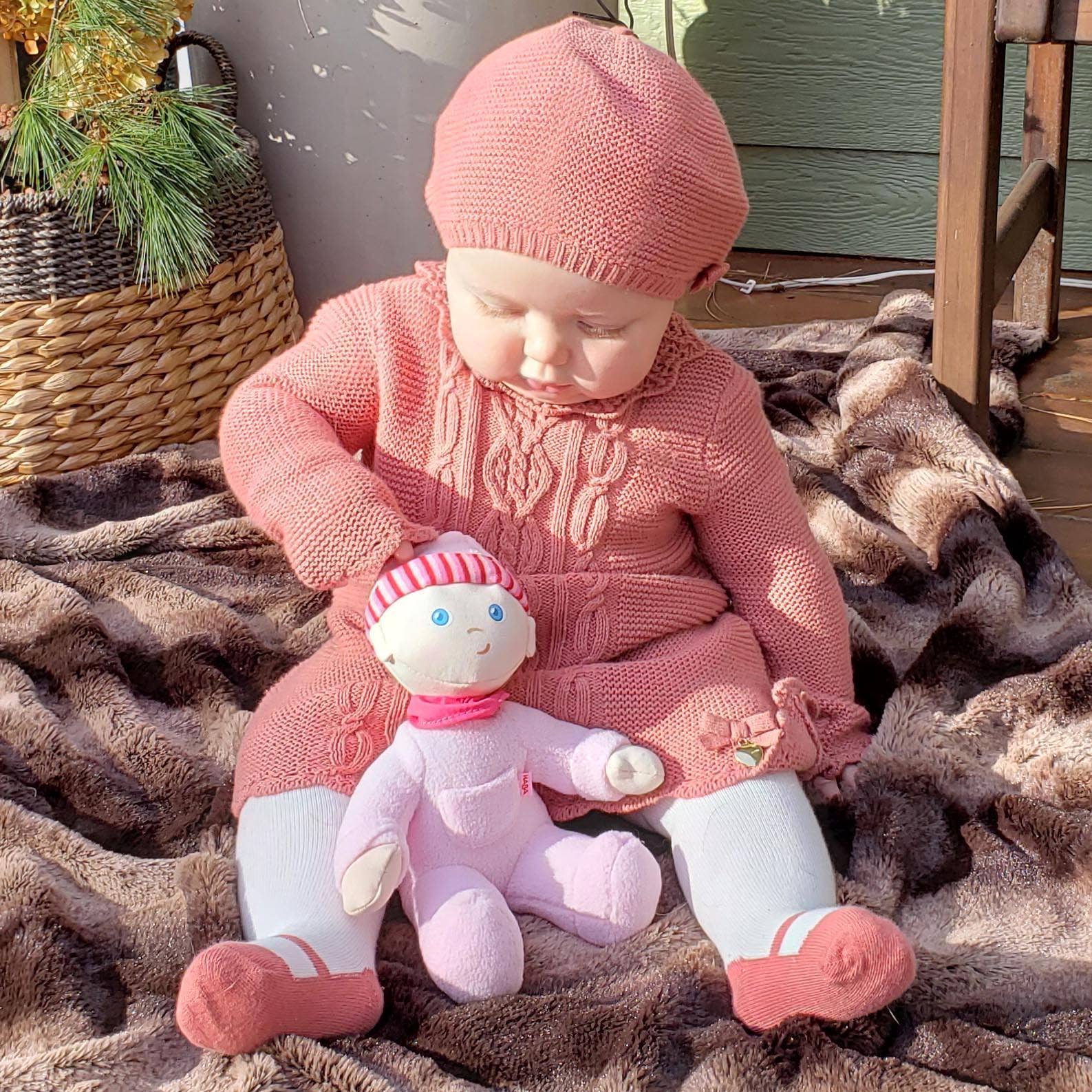 My First Snug Up Luisa baby doll sitting by HABA USA