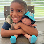 William soft doll sitting by HABA USA