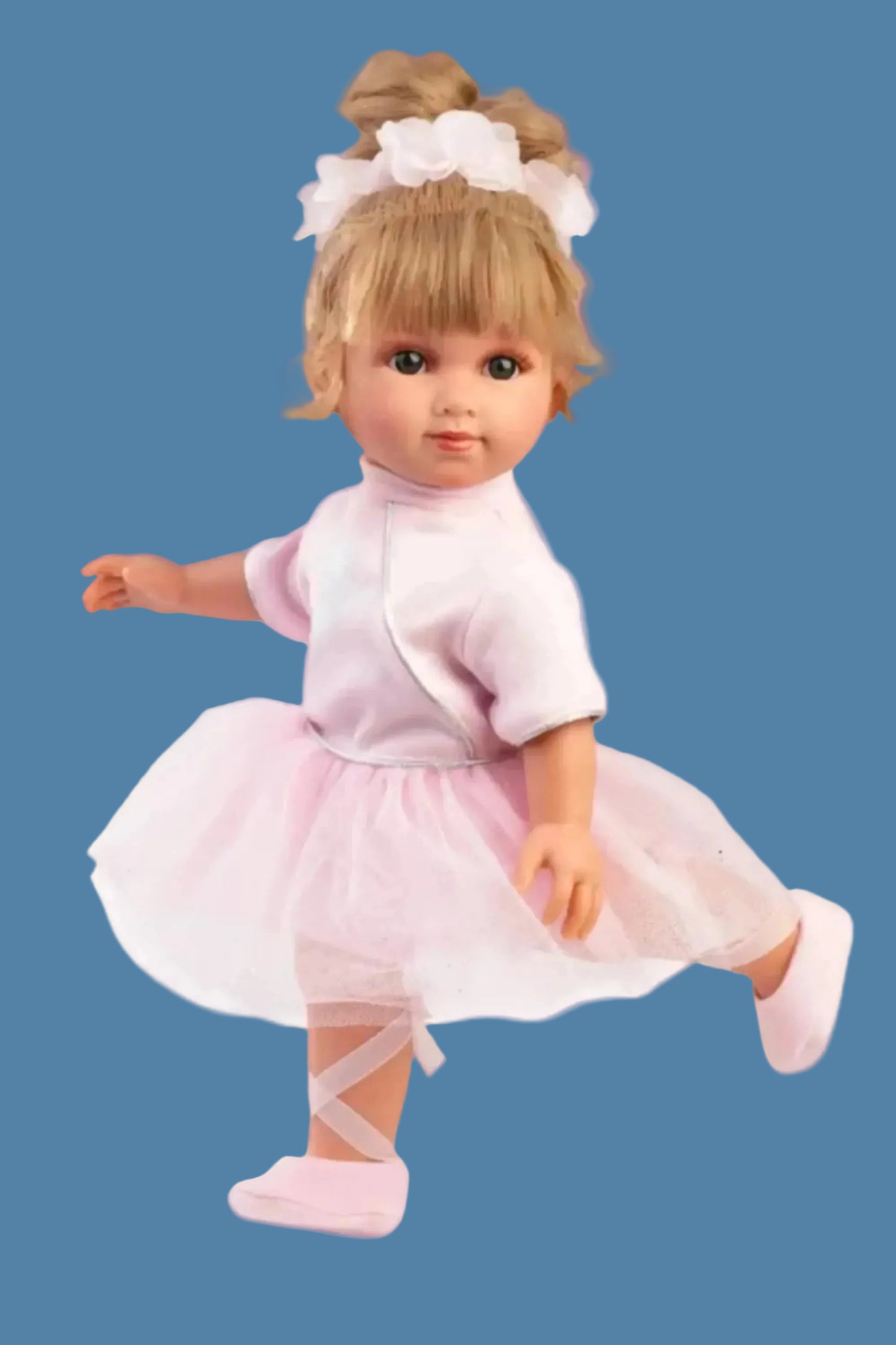 Doll in a pink outfit with a tutu on a white background