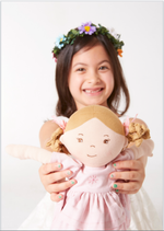Amelia doll sitting by Tikiri Toys