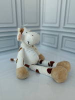 Spotted cow plush toy side view