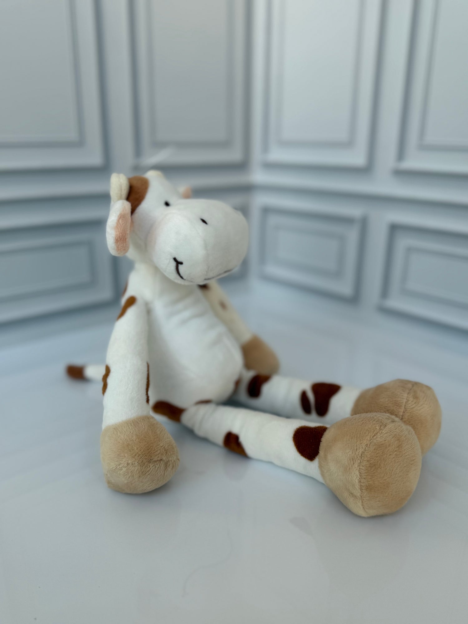 Spotted cow plush toy side view