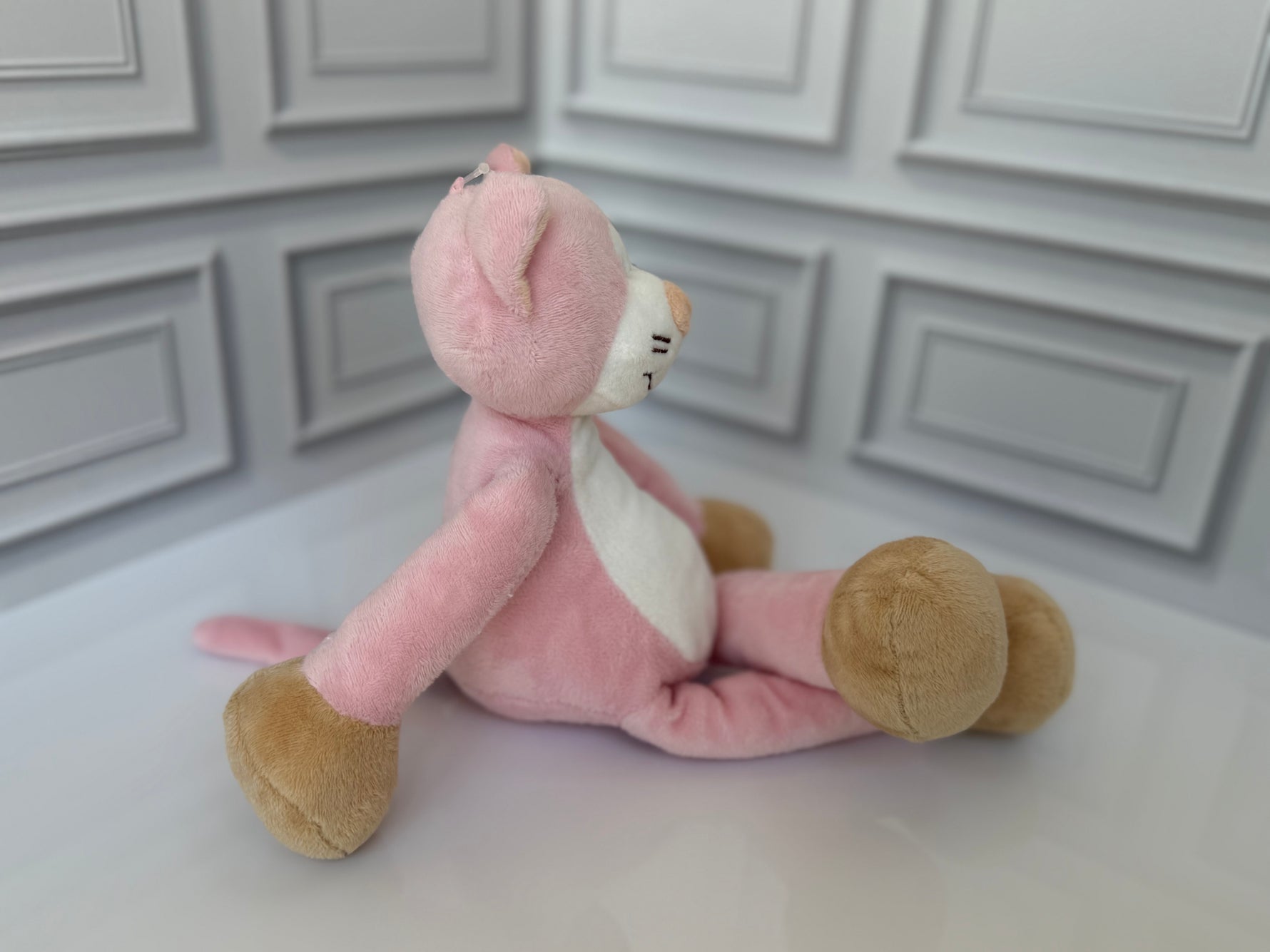 Pink cat plush toy with bow