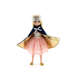 Doll in a royal outfit with a crown, cape, and dress on a white background