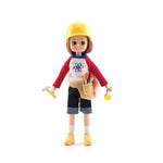 Doll in a construction worker outfit with a hard hat, tool belt, and tools on a white background