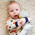 My First Snug Up Ollie baby doll sitting by HABA USA