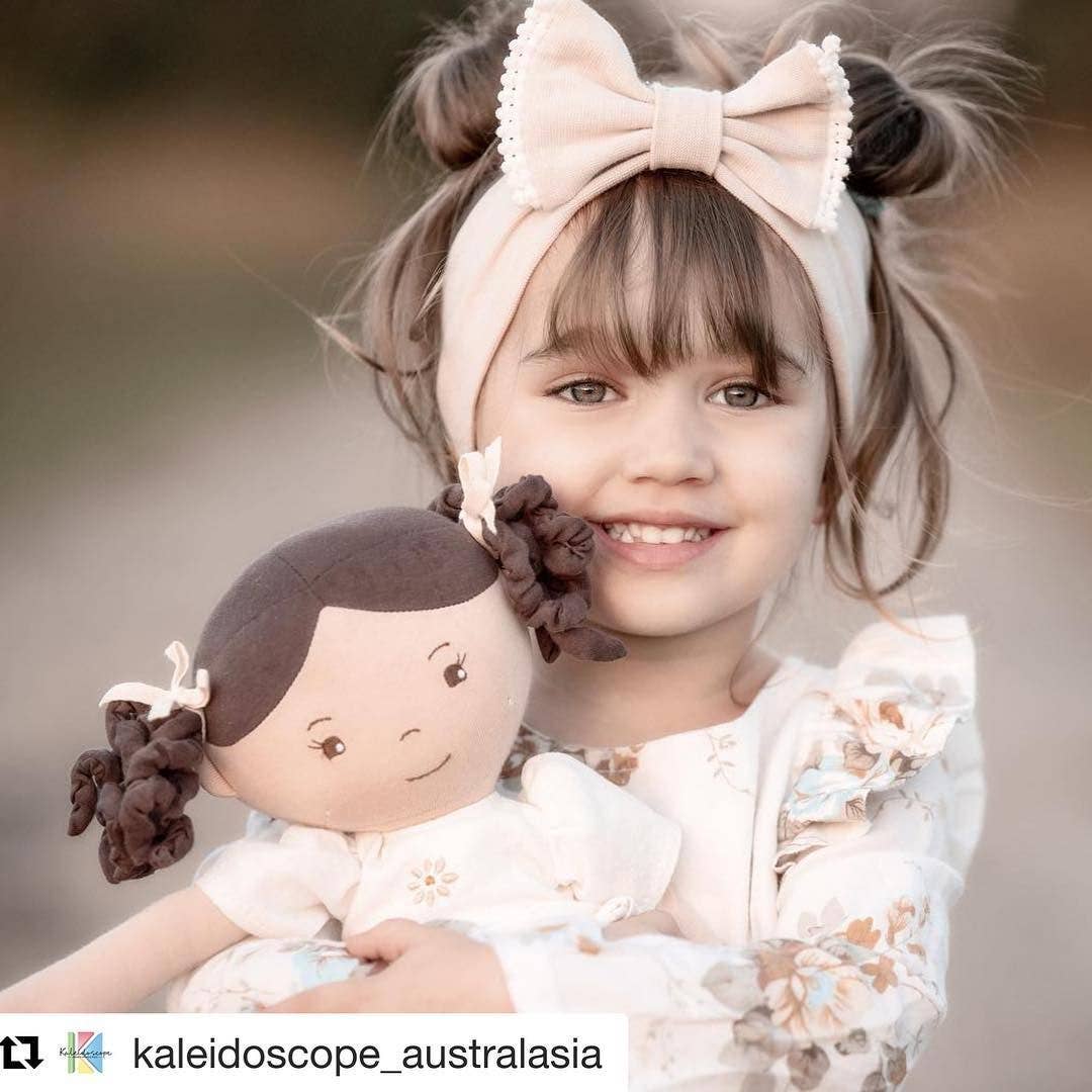 Cecilia doll sitting by Tikiri Toys