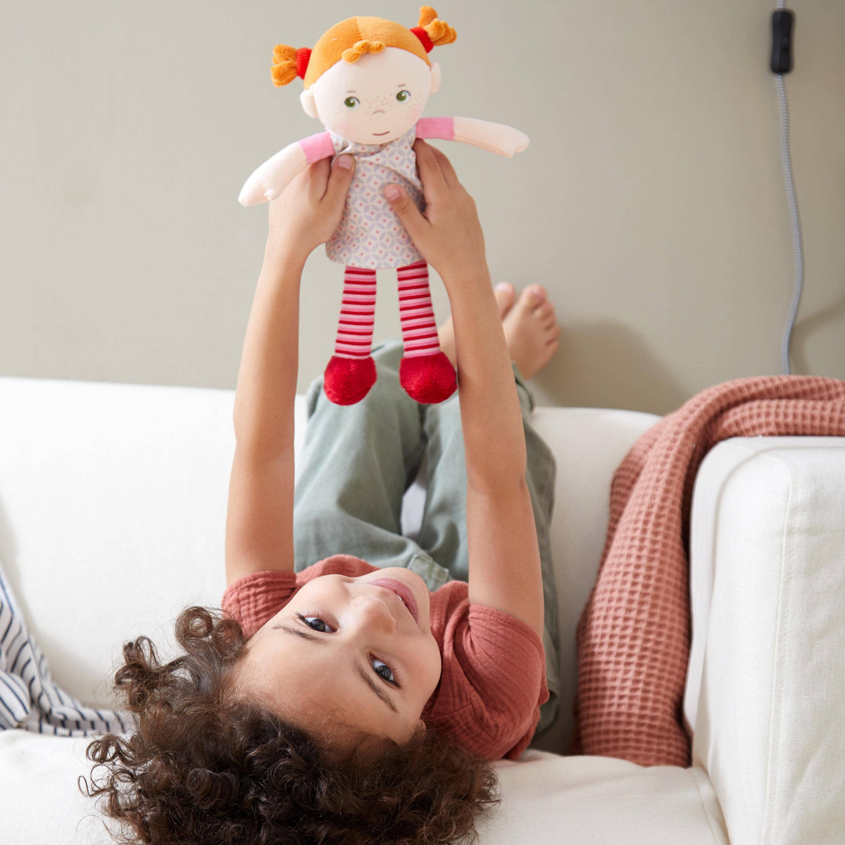 Snug Up Roya soft doll sitting by HABA USA