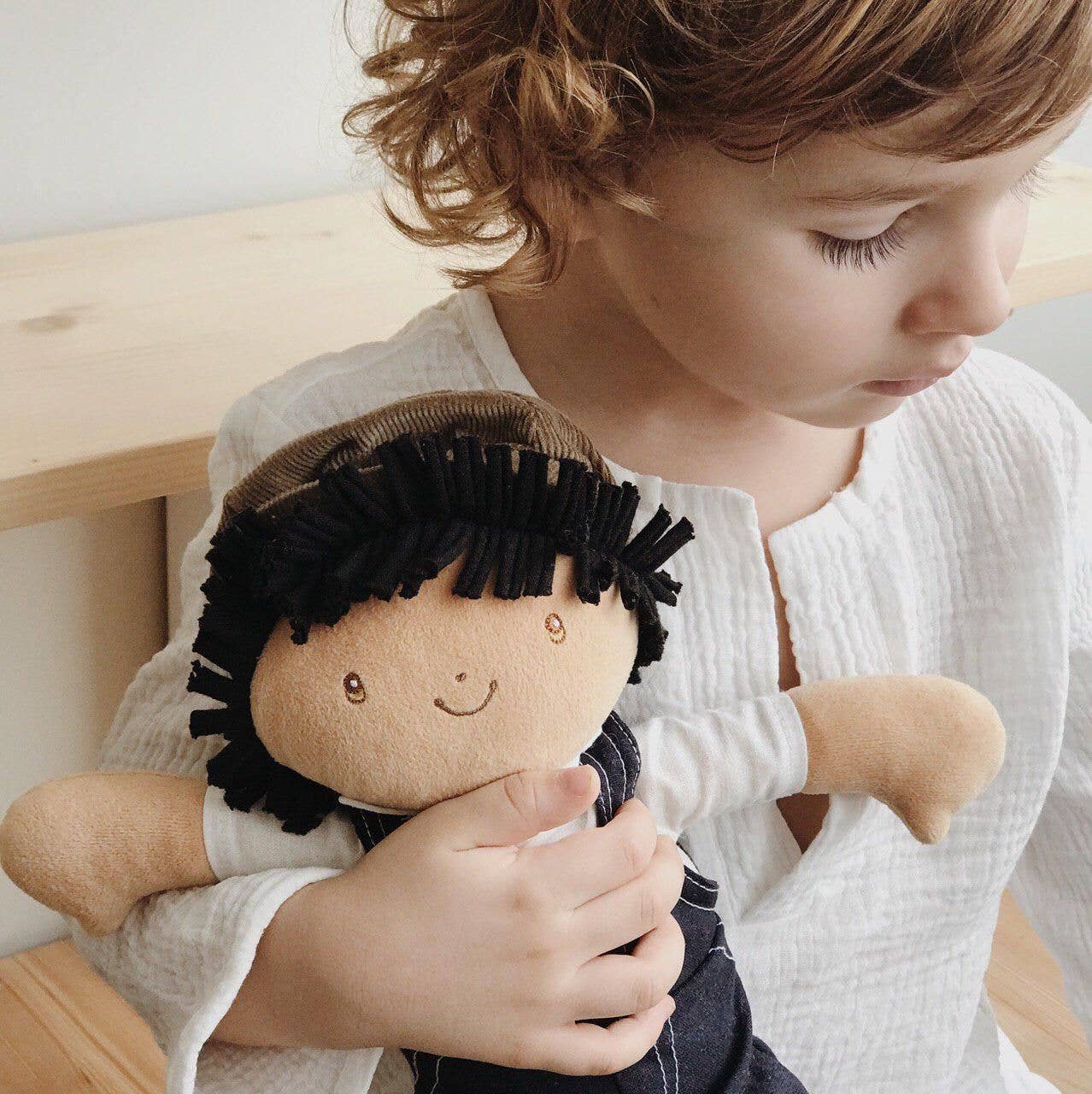Joe soft doll sitting by Tikiri Toys